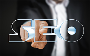 "SEO" in 3D letters in front of a person in a suit pointing at the graphic for SEO Ocean County company