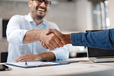 SEO Ocean County professional shaking hands with business owner while smiling