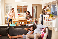 Family spread throughout open plan home relaxing comfortably indoors thanks to Monmouth County air conditioner repair.